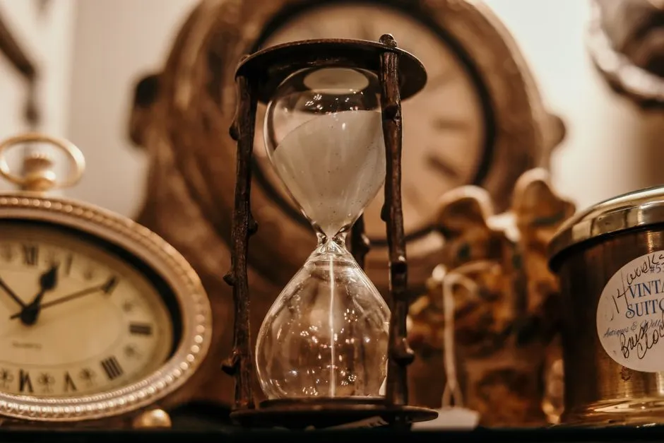Sand hourglass in shallow focus, evoking the passage of time